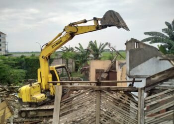 Kendaraan alat berat beko merobohkan bangunan liar yang berdiri di atas sampadan Kali Padek. Warga terdampak pembongkaran bangunan liar bakal mendapatkan jaket.