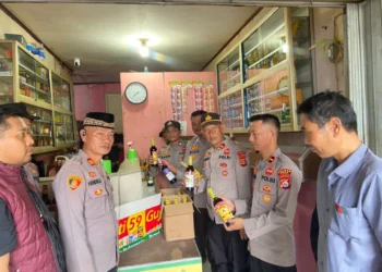 Polisi tengah menyita botol miras pada salah satu waring jamu di Kabupaten Lebak, Selasa, 17 Februari 2026.